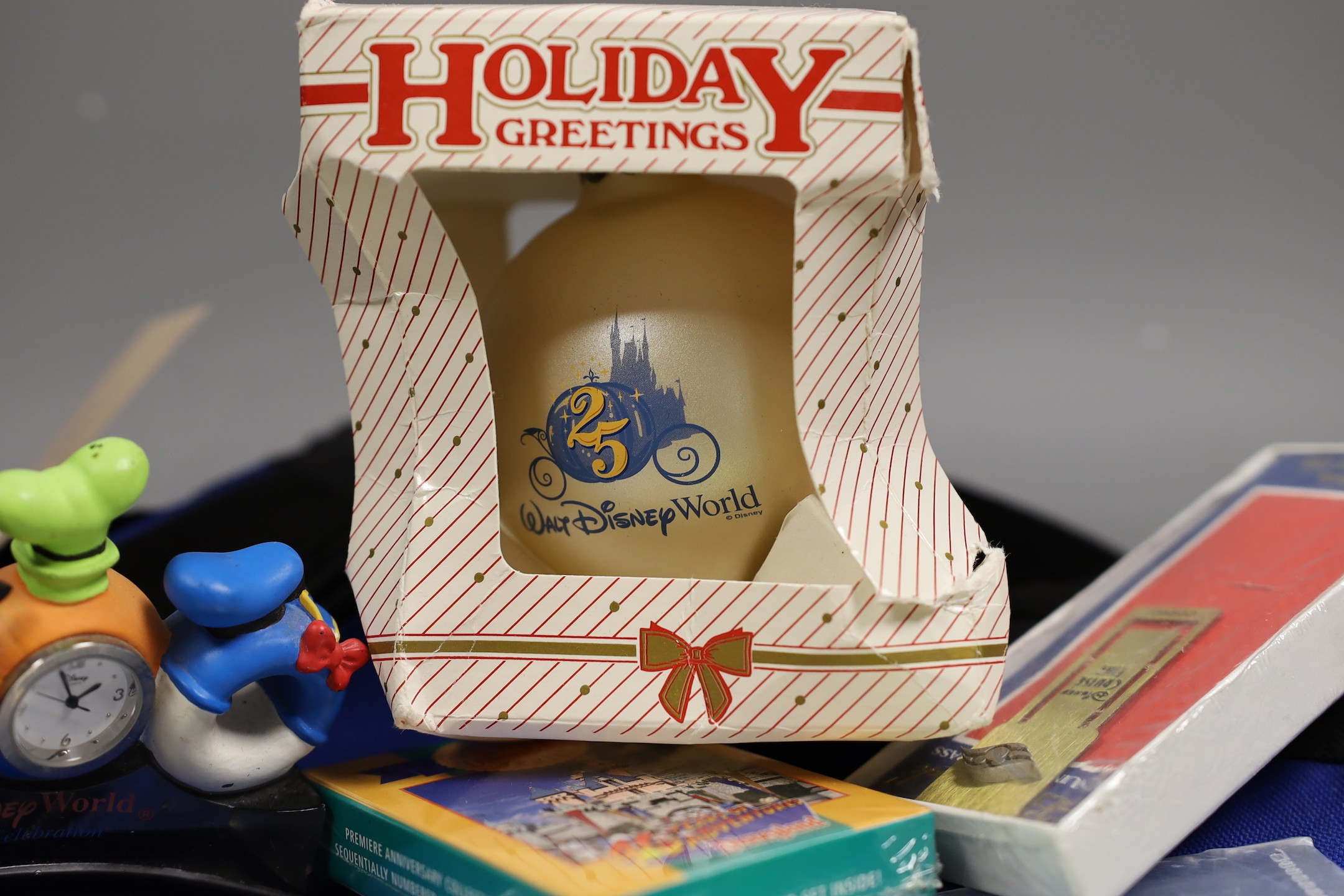 Commemorative coin, Millenium timepiece, Christmas tree ornament, bookmark, limited edition gatepasses to Disneyland, California - all Walt Disney related; also Disney canvas bag